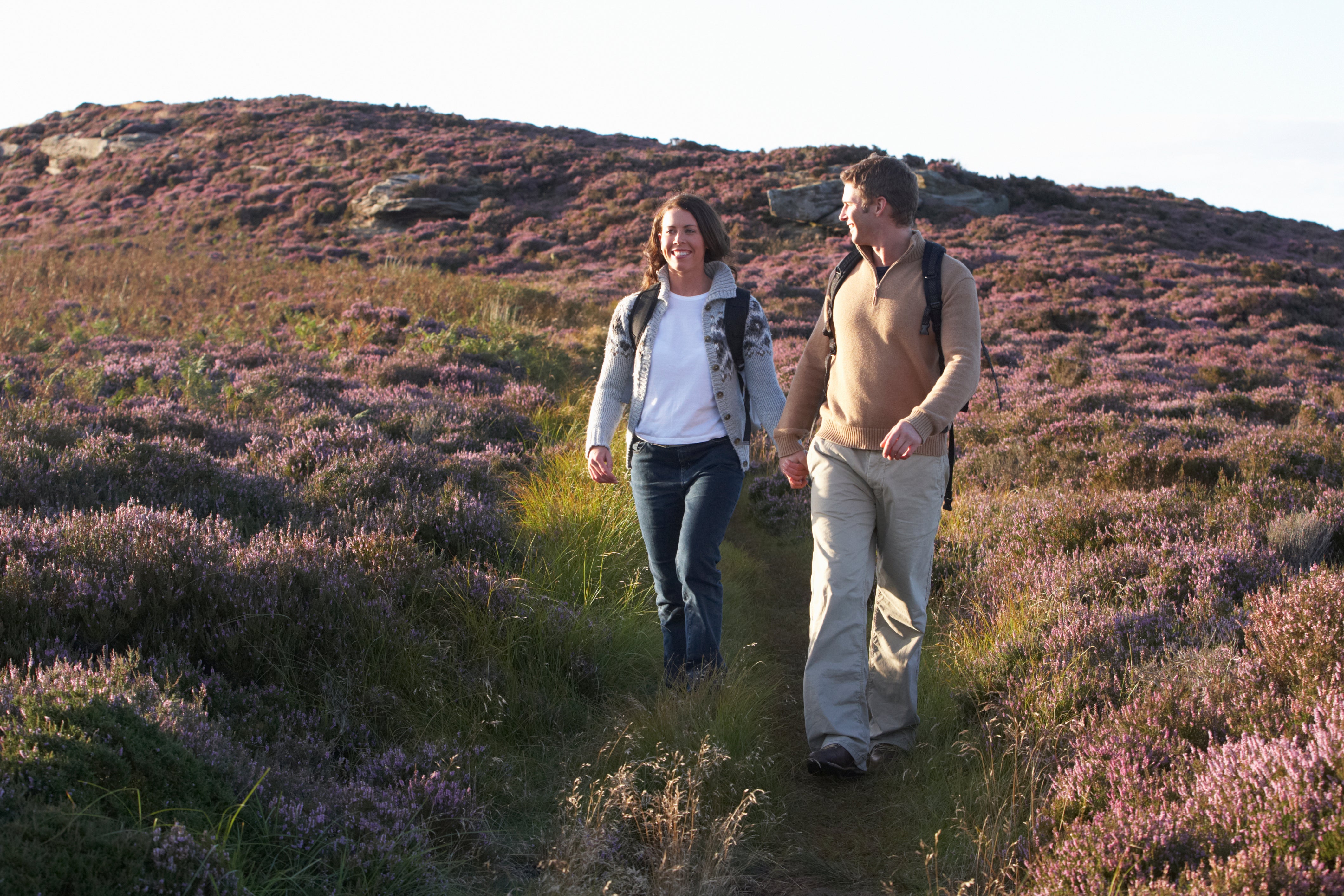Man and woman walking on a trail Man and woman walking on a trail