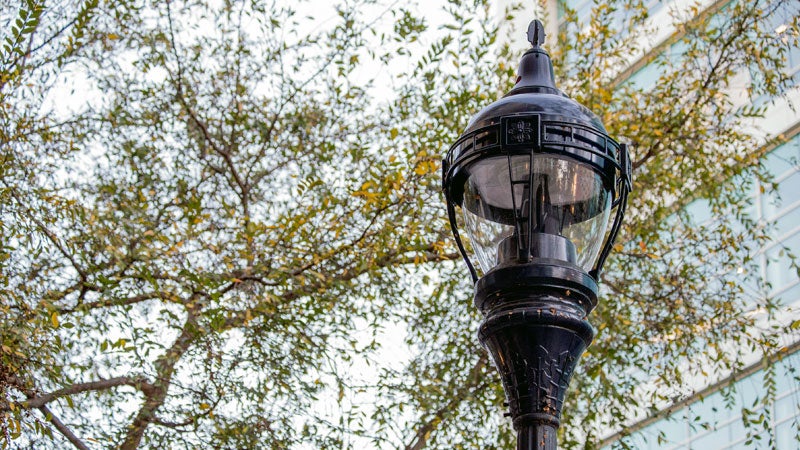 Dual LED light fixtures on top of a lamp post