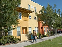 Photo of a Family Walking Through a Housing Complex