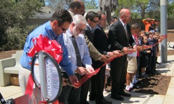 Photo of 	  Pictured left to right: 	  Serra Mesa Recreation Council Chair Jon Cima, 	  former Serra Mesa Recreation Council Chair George DeLaBarre, 	  Park and Recreation Director Herman Parker, 	  Transportation & Storm Water Deputy Director Drew Kleis, 	  Public Works ? Architectural Engineering and Parks Division Deputy Director Mark Nassar, 	  Councilmember Scott Sherman, 	  and children joining in the ribbon-cutting ceremony.	  