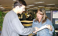 Photo of Man and Woman Working at Counter