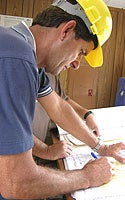Photo of Person Inspecting Plans