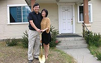 Photo of Family in Front of their Home
