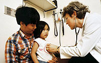 Photo of Child Being Examined by Doctor