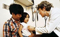 Photo of Child Being Examined by Doctor