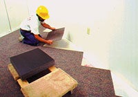 Photo of workman laying carpet