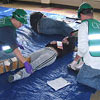 Photo of Team Members Giving Medical Care