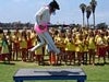 A guy playing guitar and jumping on the table