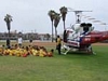 Officer talking with kids sitting down with Fire rescue Helicopter