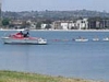 A lifeguard ship and many small boats
