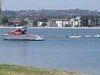 A lifeguard ship and many small boats