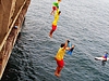Kids jumping into the water from the bridge