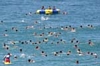 A larger number of people swimming in the water