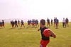 A guy throwing a ball towards a group