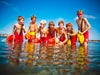 Image of seven kids standing in water