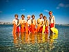 Image of seven kids standing in water