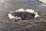 Photo of sewage spilling from a manhole Photo of sewage spilling from a manhole