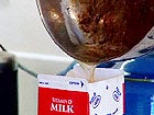Photo of Grease Being Poured Into Milk Carton