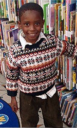 Photo of young library borrower browsing selection in the Central Library Children's Room