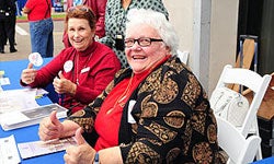 Photo of Friends of the Library advocates Marian Day and Carlene Hemric staffing the Library table at the new Central Library groundbreaking ceremony