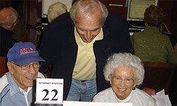 Photo of volunteer teaching seniors how to use computers at the Rancho Bernardo Branch Library 