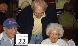 Photo of volunteer teaching seniors how to use computers at the Rancho Bernardo Branch Library