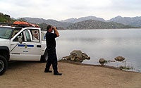 Photo of Security Guard Looking Out at Water
