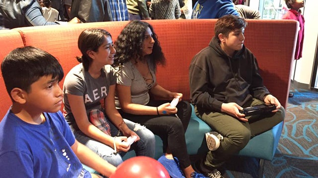 Teens playing video games inside the Legler Benbough Teen IDEA La.