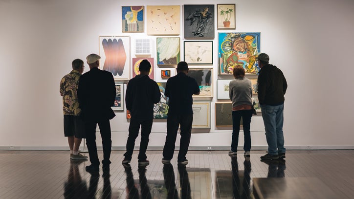 Photo of people viewing paintings