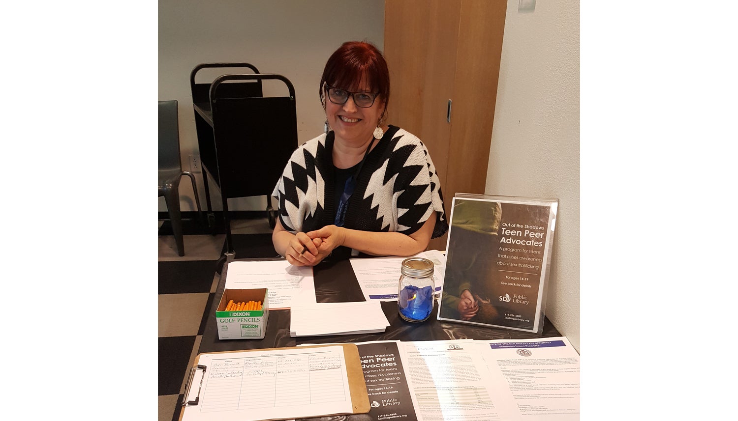 Photo of Youth Services Librarian, Marta Brandes-Miesner, welcoming attendees at a community event held at the Mira Mesa Library.