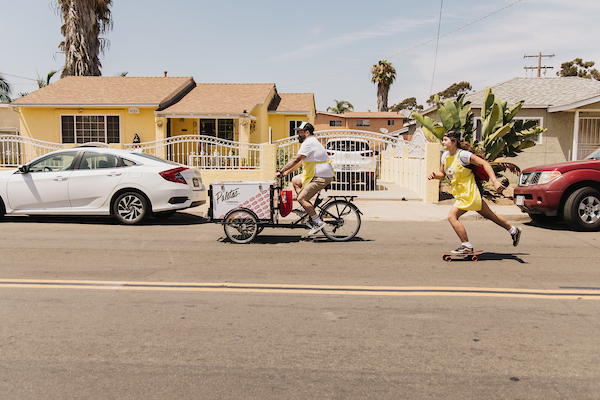 Mario Mesquita riding a vending tricycle in a San Diego neighborhood