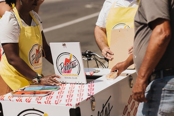 Mario Mesquita talking to San Diegans next to his vending tricycle