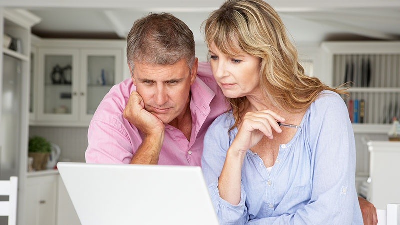 Adult couple looking at laptop monitor