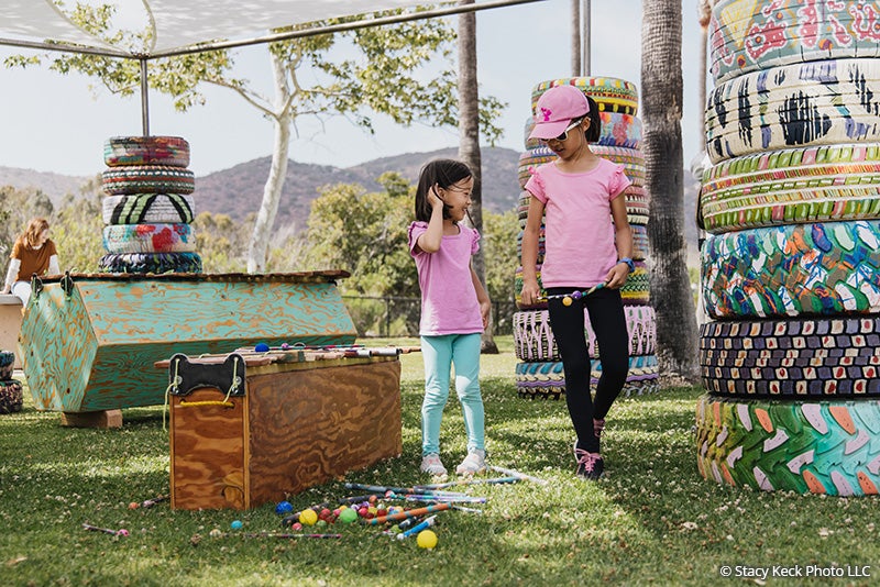 Two girls viewing the Honeycomb Harmonies art installation