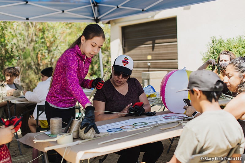 Park visitors getting information about the Collaboration with the Passerby art installation