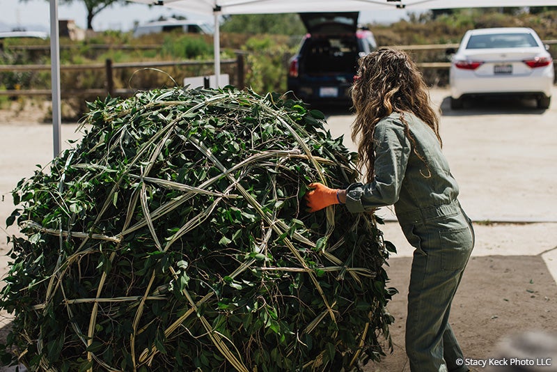 Marisol Rendon moving an art piece for the In Collaboration with the Passerby installation