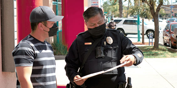 Man filing a report with a police officer