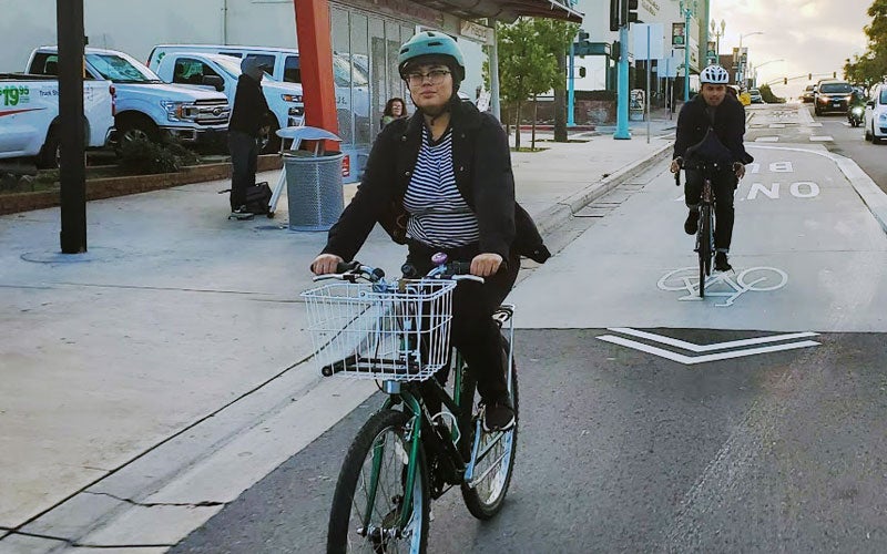 Vianney Ruvalcaba and a friend riding their bikes on a bike lane