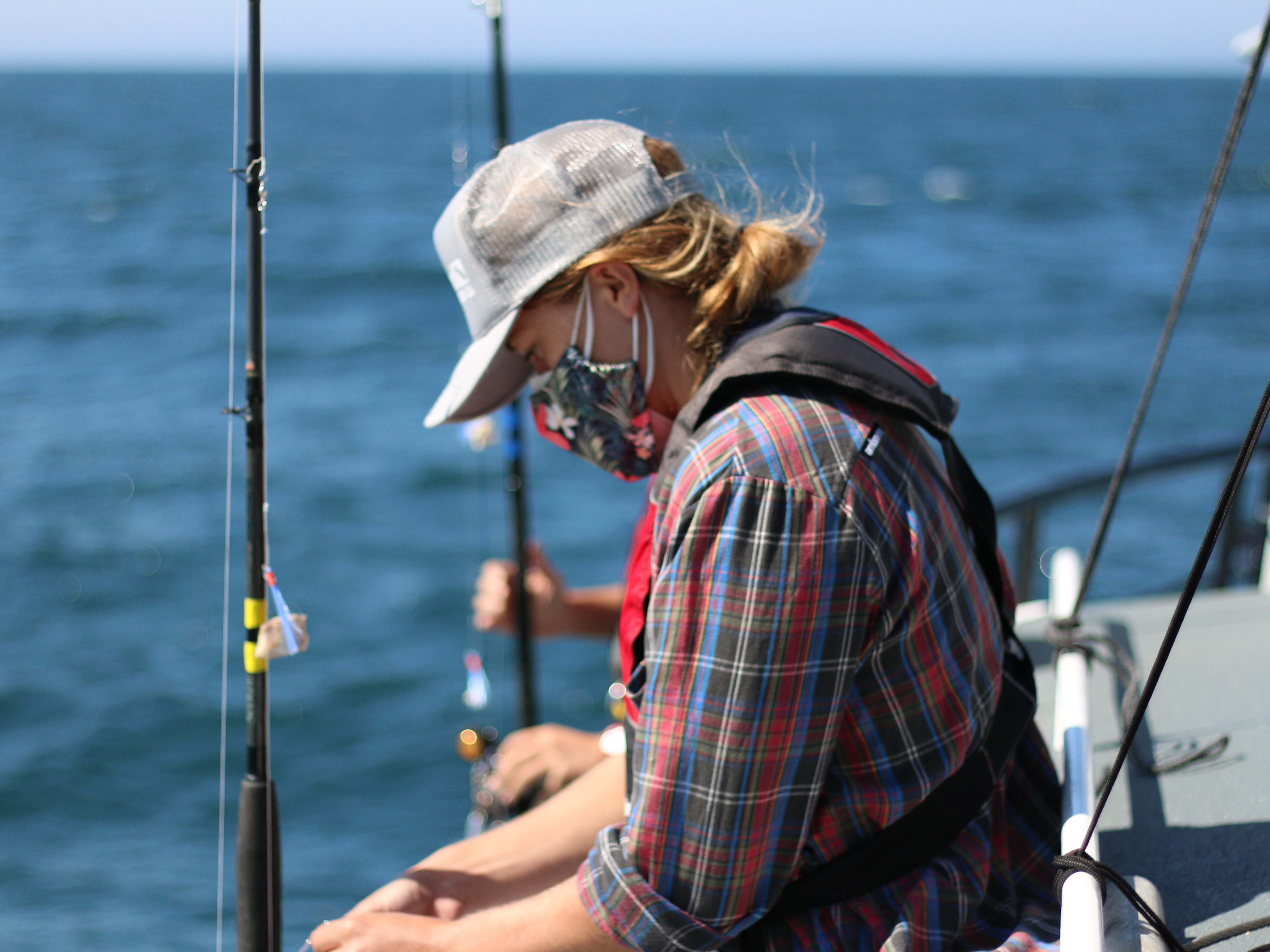 A marine biologist sets up their rig fishing rod to collect fish for tissue burden analyses that monitor the levels of potential contaminants in fish liver and muscle tissues.