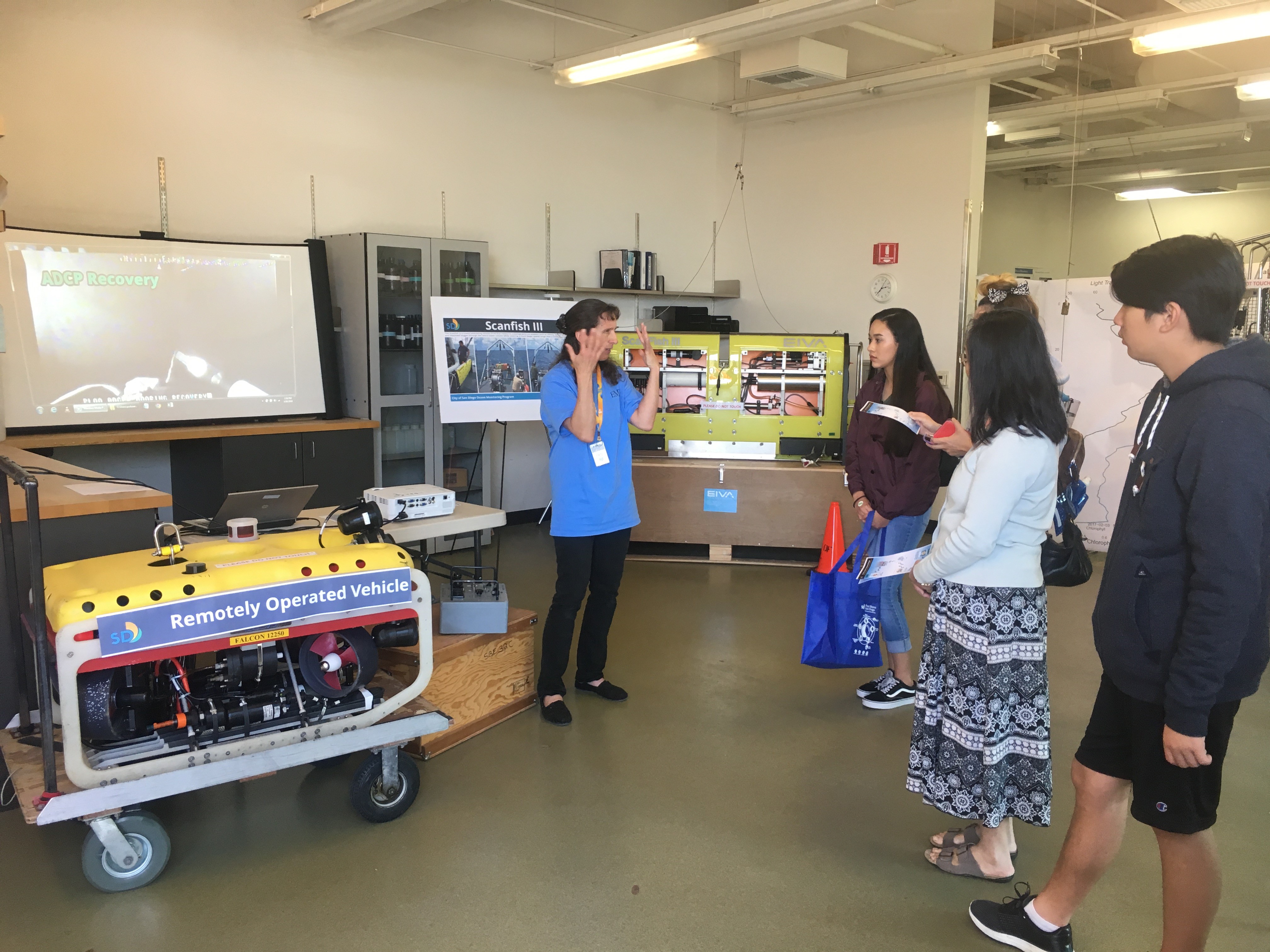 A marine biologist explains the use of the program's ROV, or remotely operated vehicle, to conduct underwater surveys.