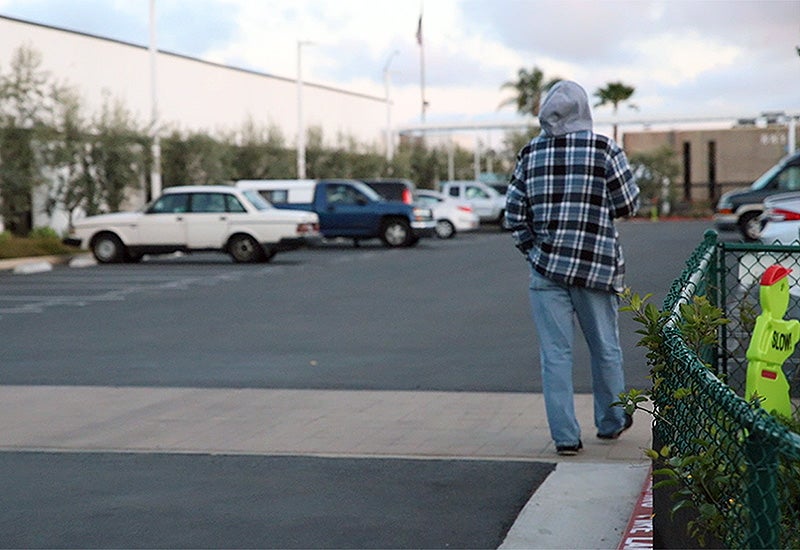 Man walking into a Safe Parking Program lot