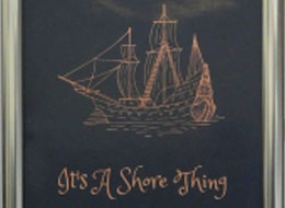 Sign for It&#039;s a Shore Thing&#44; a tall ship or frigate in pink on a navy blue background.