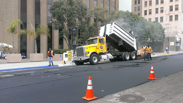 Street Division crew applying slurry seal to a downtown street.