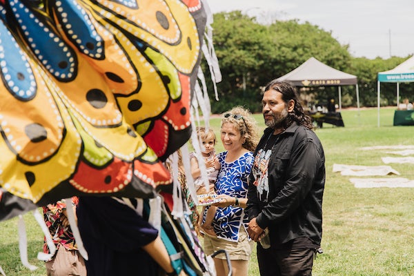 Park visitors looking at puppetry