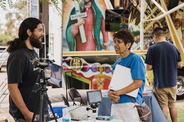 Armando de la Torre interacting with a park visitor