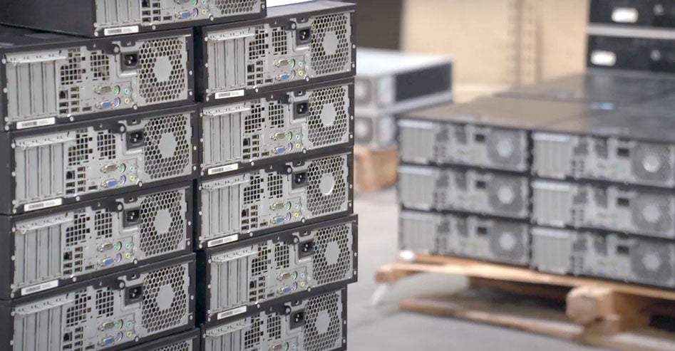 Old computers stacked in a warehouse