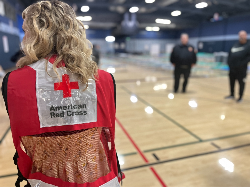 Red Cross worker standing in front of Muni Gym.