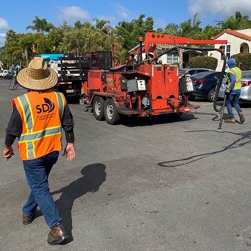 City workers sealing cracks on a road