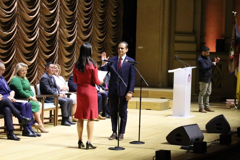 Councilmember Campillo with hand raised for inauguration