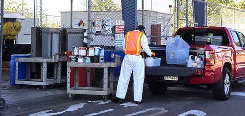 ESD staff member disposing of paint